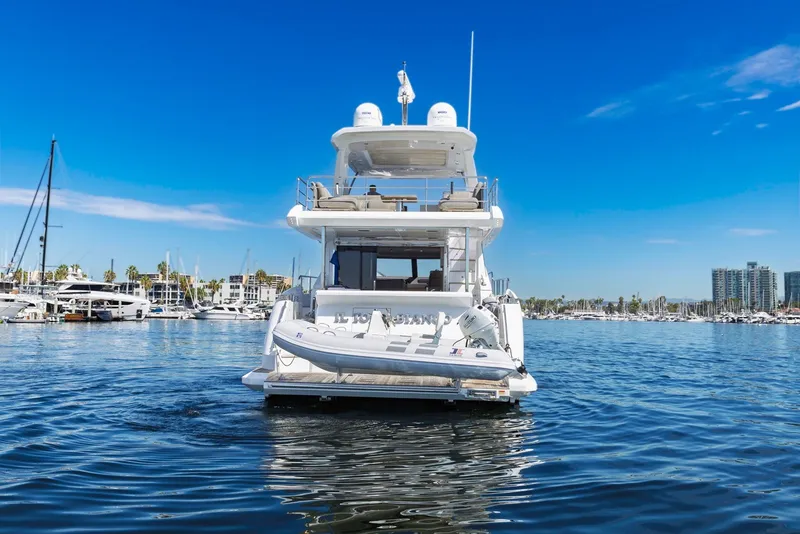 Slide: The Image of Azimut Fly 60 yacht, 2021 model, docked in a marina under clear blue skies. - 2