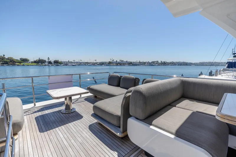 Slide: The Image of Luxurious 2021 Azimut Fly 60 yacht deck with elegant seating and scenic waterfront view. - 28