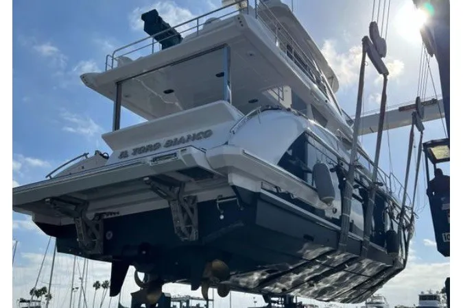 Slide: The Image of 2021 Azimut Fly 60 yacht in dry dock, rear view under sunny sky. - 72