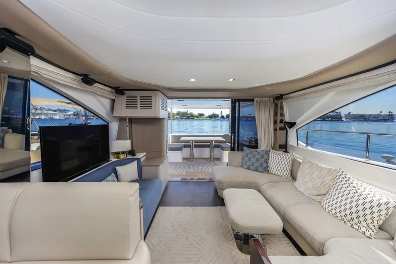 Slide: The Image of Luxurious interior of 2021 Azimut Fly 60 yacht with elegant seating and panoramic windows. - 60