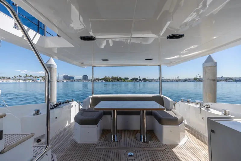 Slide: The Image of Luxurious 2021 Azimut Fly 60 yacht deck with seating, overlooking serene marina waters. - 15