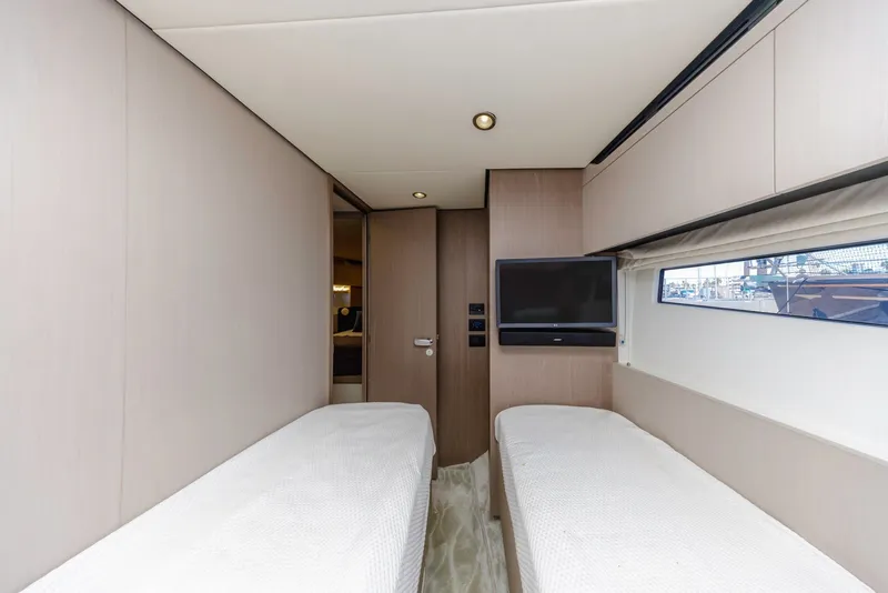 Slide: The Image of Interior of 2021 Azimut Fly 60 yacht with twin beds and a wall-mounted TV. - 51