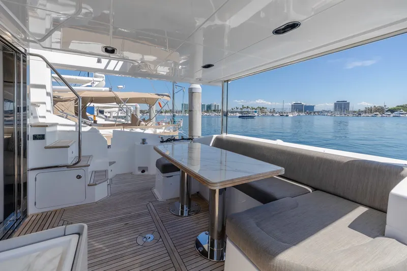 Slide: The Image of Luxurious 2021 Azimut Fly 60 yacht deck with elegant seating and scenic marina view. - 13