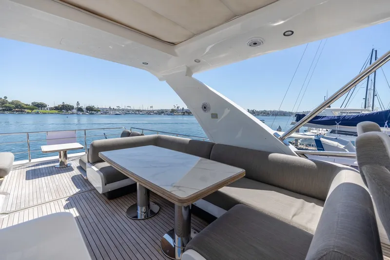 Slide: The Image of Luxurious 2021 Azimut Fly 60 yacht deck with elegant seating and scenic waterfront view. - 26