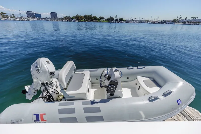 Slide: The Image of Inflatable boat with Suzuki motor docked on calm water, near Azimut Fly 60 yacht. - 16