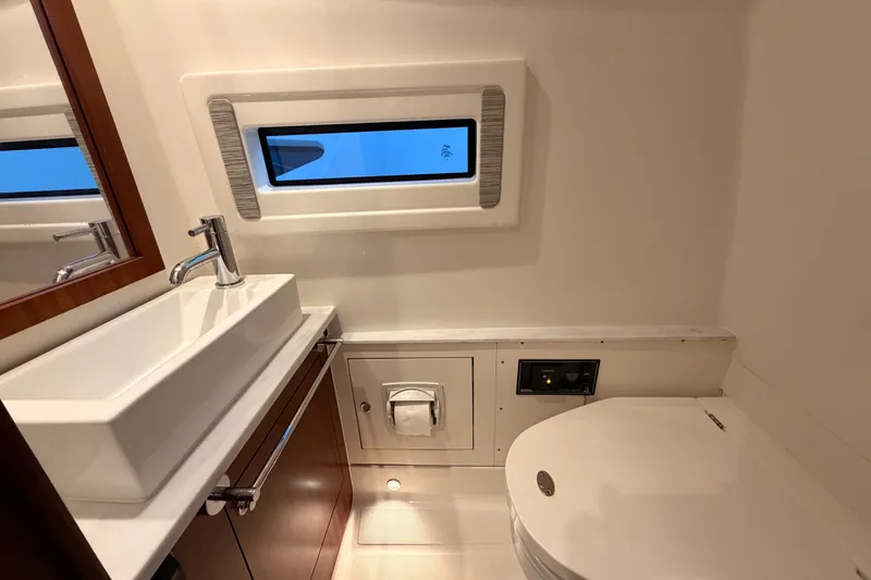 Slide: The Image of Luxurious bathroom interior of 2022 Pursuit S 378 Sport boat, featuring modern sink and toilet. - 28