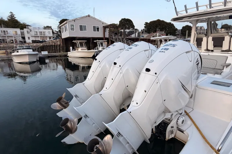 Slide: The Image of 2022 Pursuit S 378 Sport boat with triple Yamaha outboard engines docked in a marina. - 3