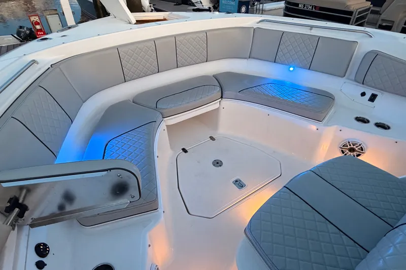Slide: The Image of Luxurious seating area on a 2022 Pursuit S 378 Sport boat with ambient lighting. - 13
