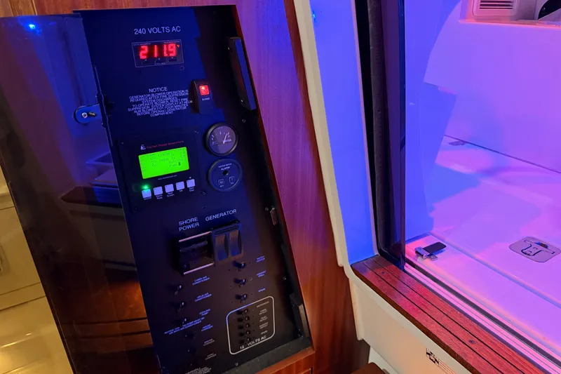 Slide: The Image of Electrical panel on 2022 Pursuit S 378 Sport boat, displaying 240 volts AC. - 50