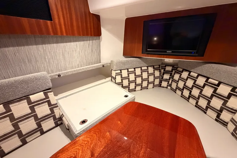Slide: The Image of Interior of 2022 Pursuit S 378 Sport boat with wood accents and modern seating. - 55