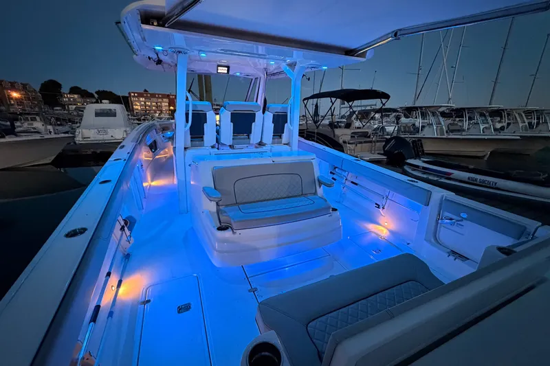 Slide: The Image of 2022 Pursuit S 378 Sport boat with blue LED deck lighting at marina. - 33