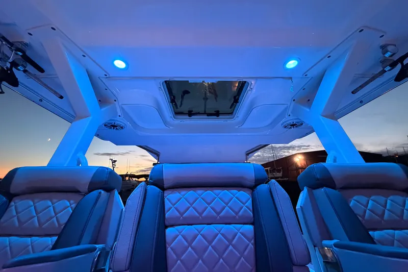 Slide: The Image of Luxurious interior of 2022 Pursuit S 378 Sport boat with ambient blue lighting at sunset. - 39