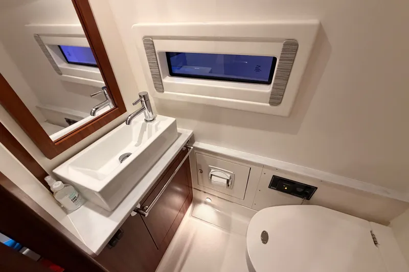 Slide: The Image of Luxurious bathroom interior of 2022 Pursuit S 378 Sport boat, featuring modern sink and window. - 57