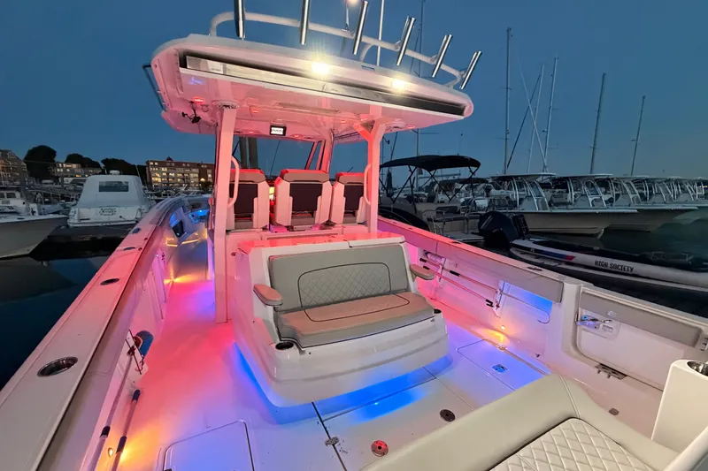 Slide: The Image of 2022 Pursuit S 378 Sport boat with colorful LED lighting at a marina. - 30