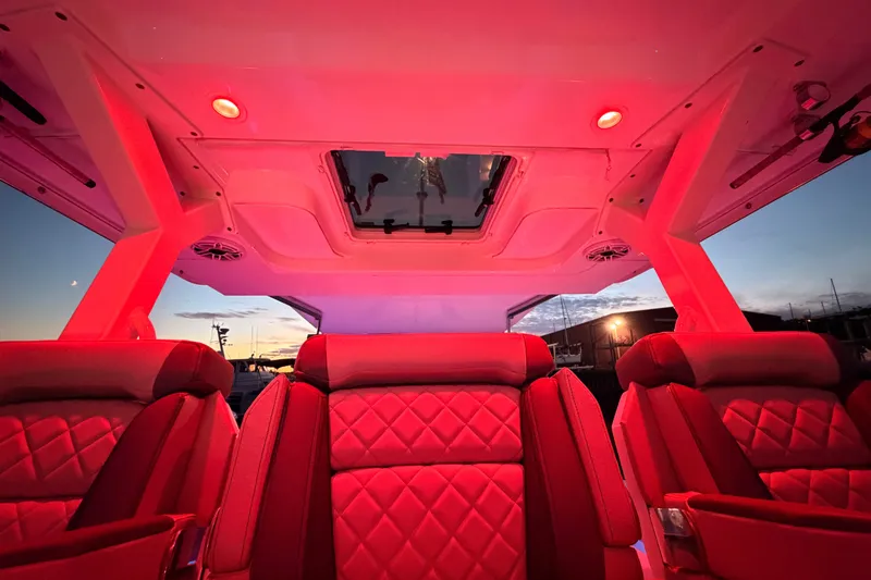 Slide: The Image of Luxurious interior of 2022 Pursuit S 378 Sport boat with red ambient lighting at sunset. - 37