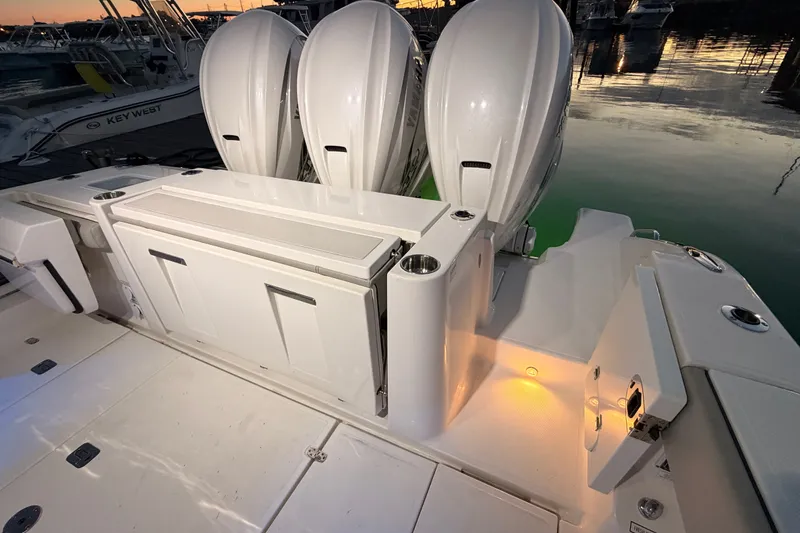 Slide: The Image of 2022 Pursuit S 378 Sport boat with triple outboard engines at sunset. - 45