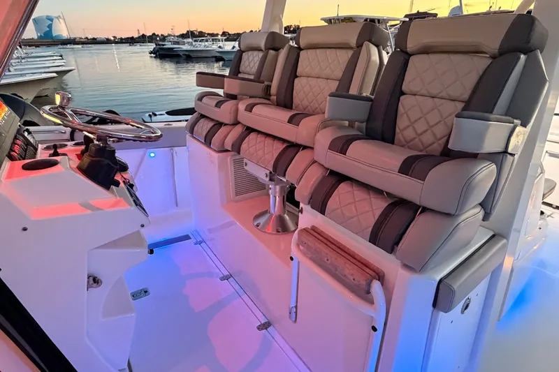 Slide: The Image of Luxurious seating on 2022 Pursuit S 378 Sport boat at sunset marina. - 16