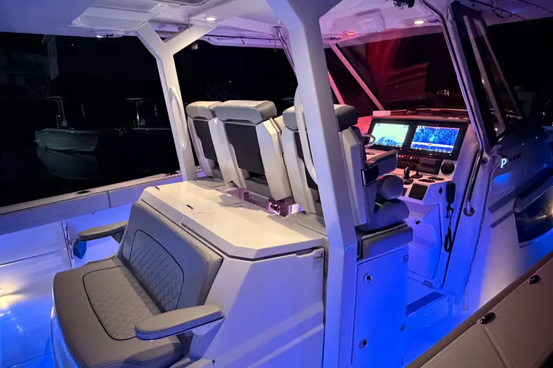 Slide: The Image of 2022 Pursuit S 378 Sport boat interior with illuminated cockpit and advanced navigation system. - 23
