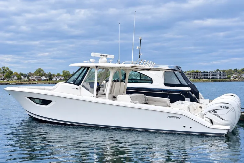 The Image of 2022 Pursuit S 378 Sport boat on calm water, featuring Yamaha engines. - 0