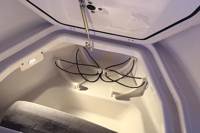 Slide: The Image of 2022 Pursuit S 378 Sport boat storage compartment with lighting and secure straps. - 6