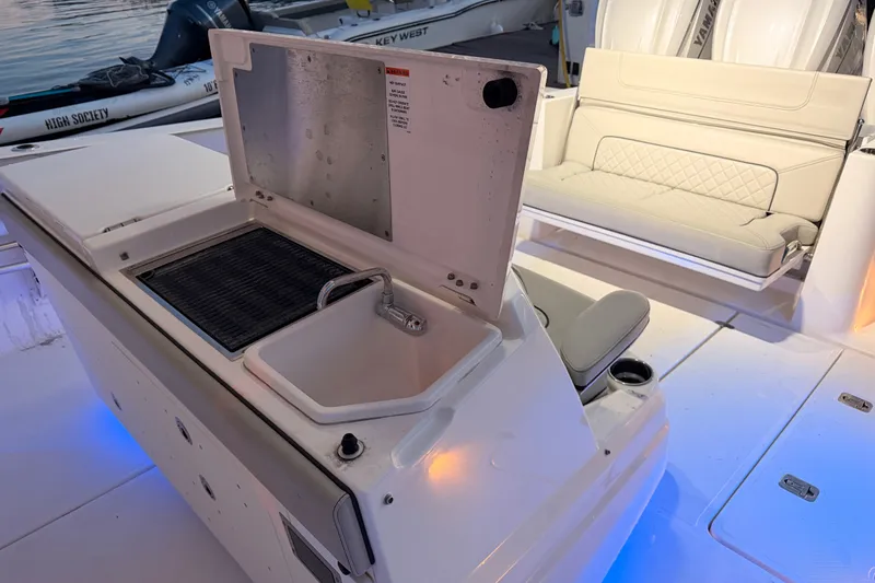 Slide: The Image of 2022 Pursuit S 378 Sport boat interior with sink and seating area. - 41