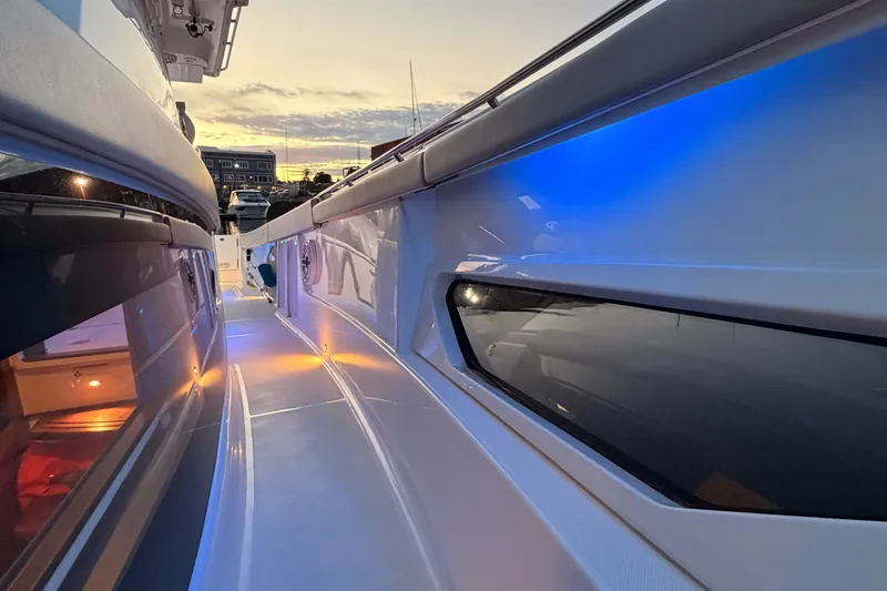 Slide: The Image of 2022 Pursuit S 378 Sport boat deck with ambient lighting at sunset. - 15