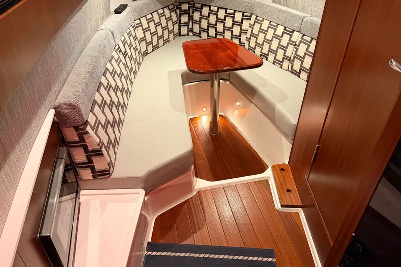 Slide: The Image of Luxurious interior of 2022 Pursuit S 378 Sport boat with elegant seating and wooden table. - 53