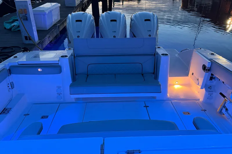 Slide: The Image of 2022 Pursuit S 378 Sport boat interior with illuminated seating and triple V8 engines. - 35