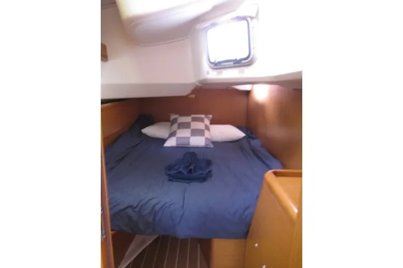 Slide: The Image of Cozy cabin interior of 2013 Jeanneau Sun Odyssey 44i sailboat with bed and window. - 14