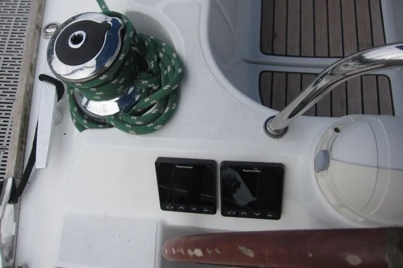 Slide: The Image of Cockpit of 2013 Jeanneau Sun Odyssey 44i with winch, rope, and navigation instruments. - 23