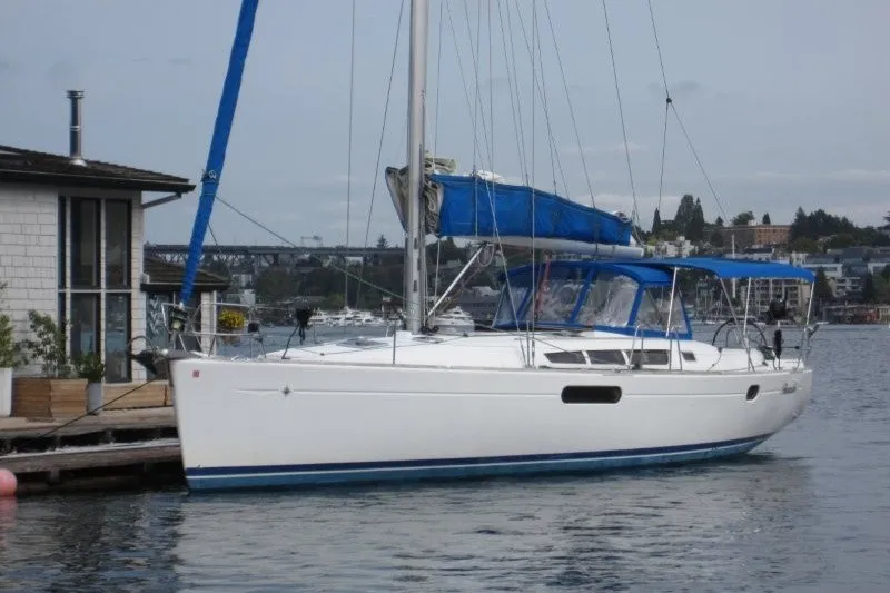 Slide: The Image of 2013 Jeanneau Sun Odyssey 44i sailboat docked by a waterfront house. - 32