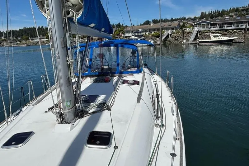 Slide: The Image of 2013 Jeanneau Sun Odyssey 44i sailboat docked in a serene marina setting. - 25