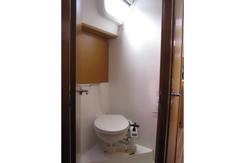 Slide: The Image of Bathroom interior of 2013 Jeanneau Sun Odyssey 44i yacht, featuring compact marine toilet. - 18