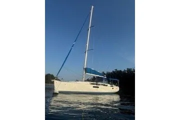 Slide: The Image of 2013 Jeanneau Sun Odyssey 44i sailboat on calm water under clear sky. - 29