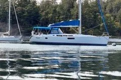 Slide: The Image of 2013 Jeanneau Sun Odyssey 44i sailboat anchored on calm water with forest backdrop. - 26