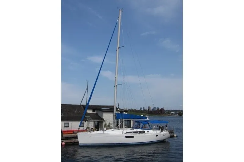 Slide: The Image of 2013 Jeanneau Sun Odyssey 44i sailboat docked by a waterfront house. - 31