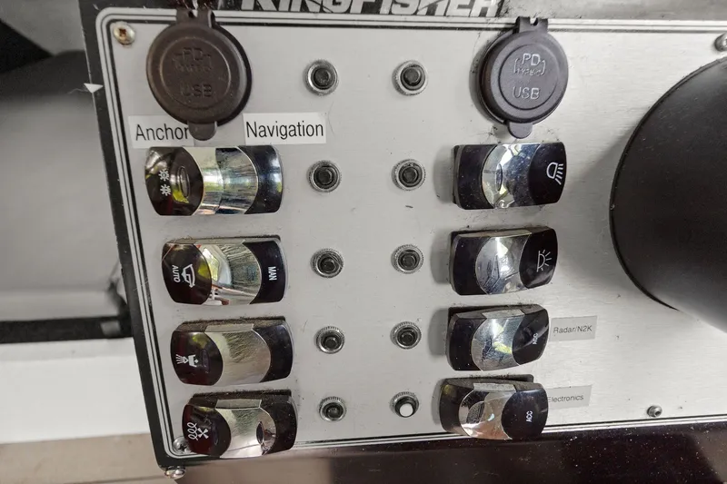 Slide: The Image of Control panel of a 2021 KingFisher 2625 Coastal Express boat with labeled switches. - 33
