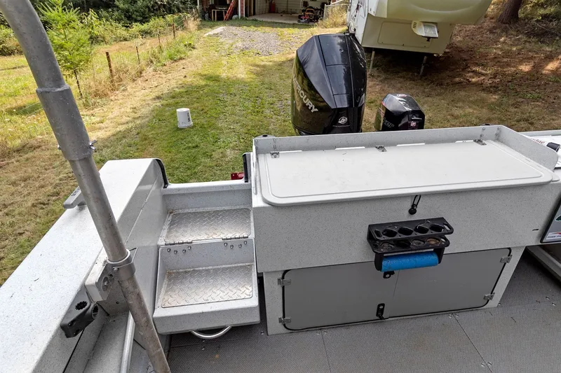 Slide: The Image of 2021 KingFisher 2625 Coastal Express boat with Mercury outboard motor, docked on grass. - 18