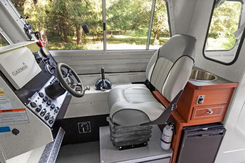 Slide: The Image of Interior of 2021 KingFisher 2625 Coastal Express boat with steering wheel and control panel. - 38