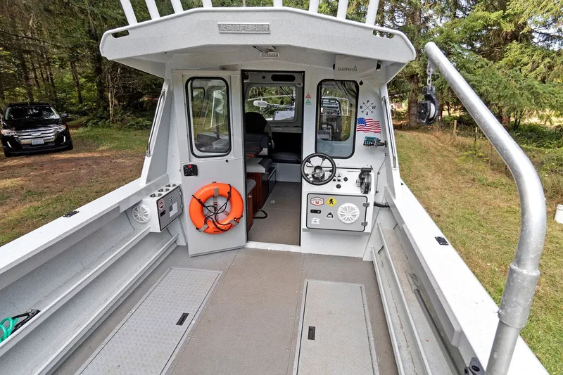 Slide: The Image of 2021 KingFisher 2625 Coastal Express boat interior with steering wheel and safety equipment. - 16