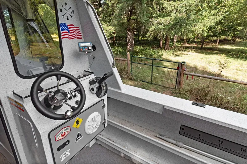 Slide: The Image of Interior of 2021 KingFisher 2625 Coastal Express boat with steering wheel and control panel. - 26