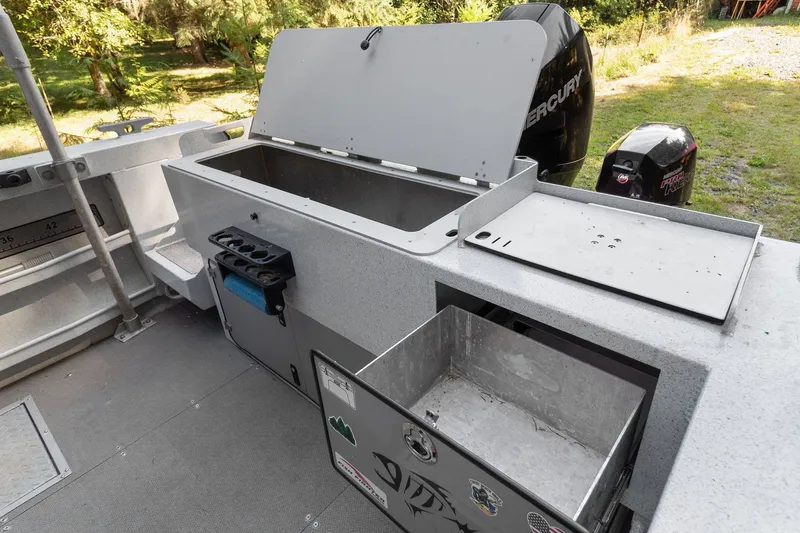 Slide: The Image of 2021 KingFisher 2625 Coastal Express boat interior with storage compartments and Mercury engine. - 44
