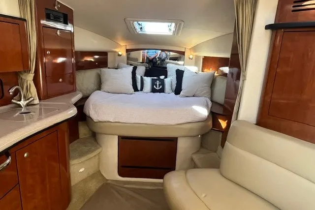 Slide: The Image of Luxurious interior of 2007 Sea Ray Sundancer 320 yacht with cozy bed and elegant wood finishes. - 44