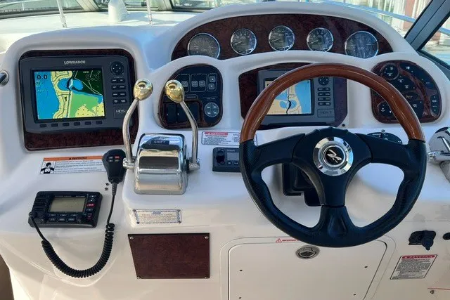 Slide: The Image of Dashboard of 2007 Sea Ray Sundancer 320 with navigation screens and controls. - 10