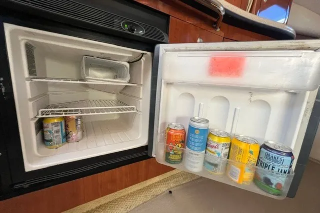 Slide: The Image of Mini fridge inside 2007 Sea Ray Sundancer 320 yacht, stocked with assorted canned beverages. - 40