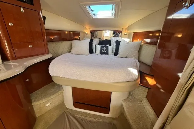Slide: The Image of 2007 Sea Ray Sundancer 320 cabin interior with cozy bed and nautical decor. - 46