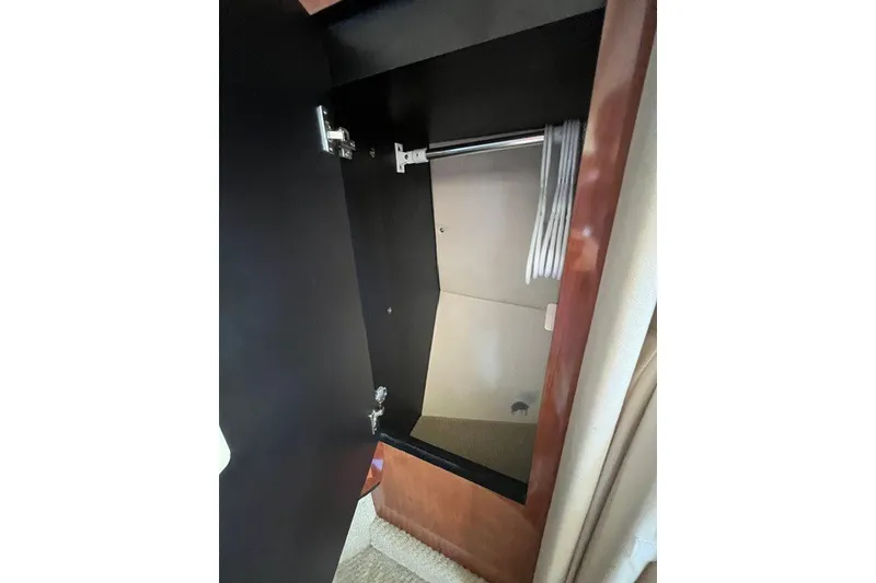 Slide: The Image of Open closet with hangers inside a 2007 Sea Ray Sundancer 320 yacht. - 48