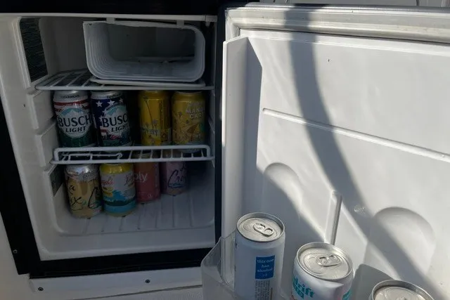 Slide: The Image of Mini fridge stocked with assorted drinks on a 2007 Sea Ray Sundancer 320 boat. - 22
