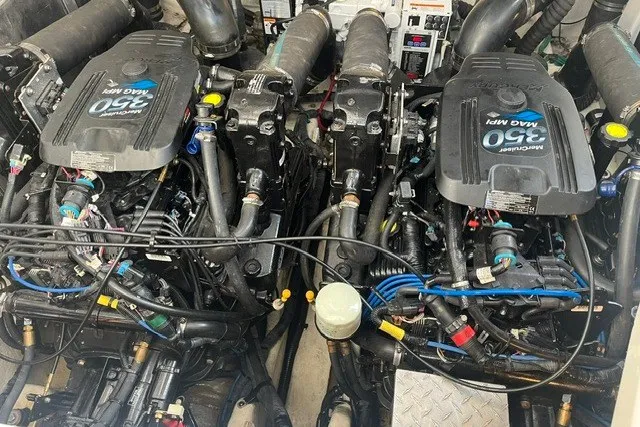 Slide: The Image of Twin engines of a 2007 Sea Ray Sundancer 320 boat, showcasing detailed mechanical components. - 53