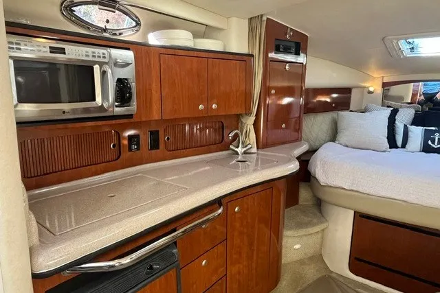 Slide: The Image of Luxurious 2007 Sea Ray Sundancer 320 interior with kitchenette and cozy sleeping area. - 34